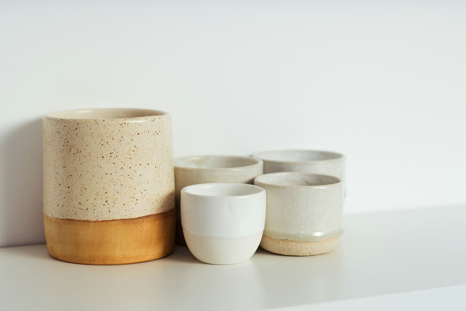 Glazed ceramic cups in white and brown
