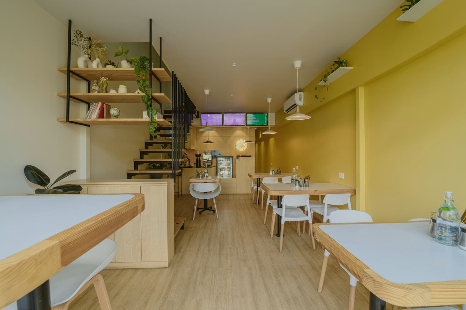 A yellow-walled café with wooden tables