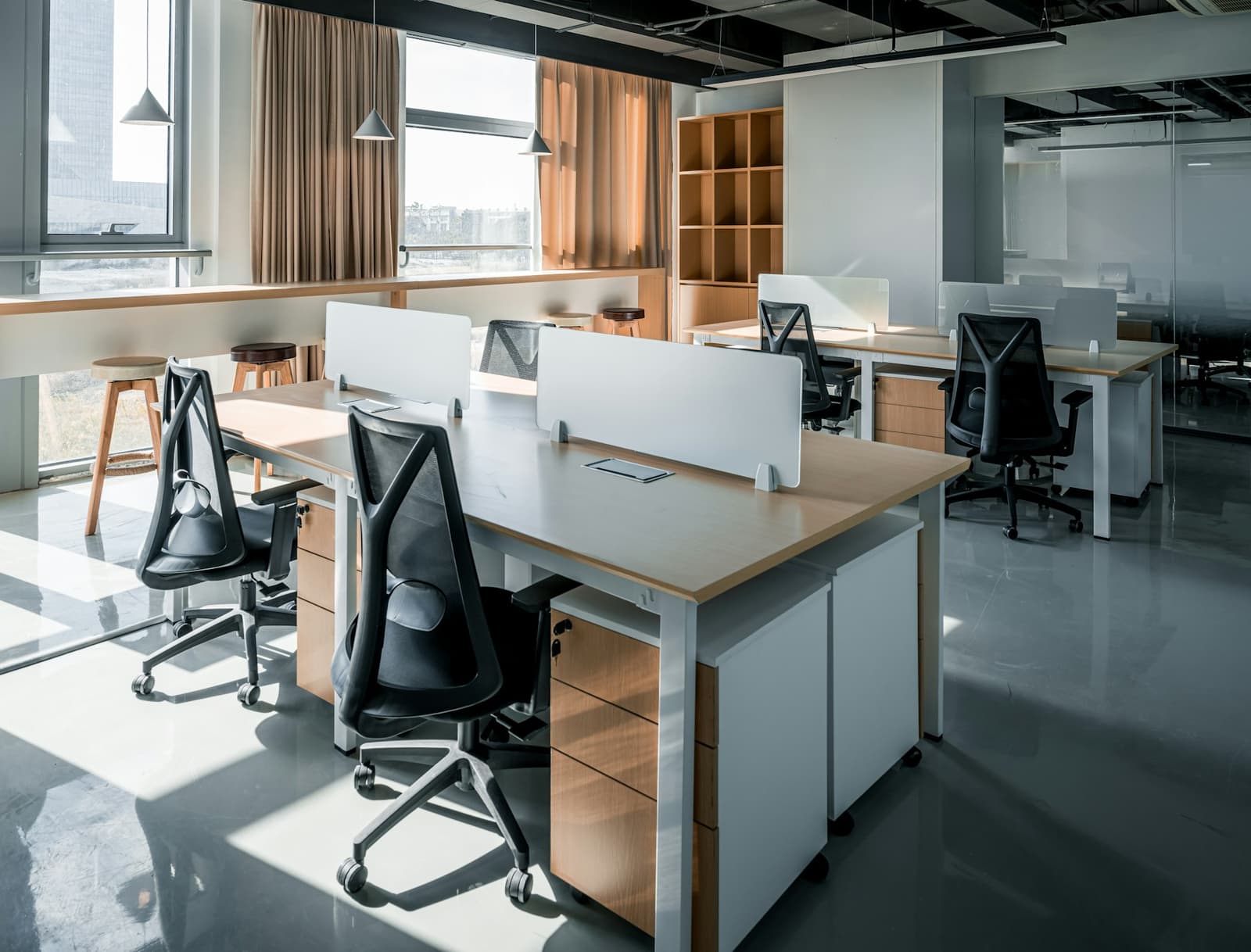 An empty open-plan office with desks and chairs