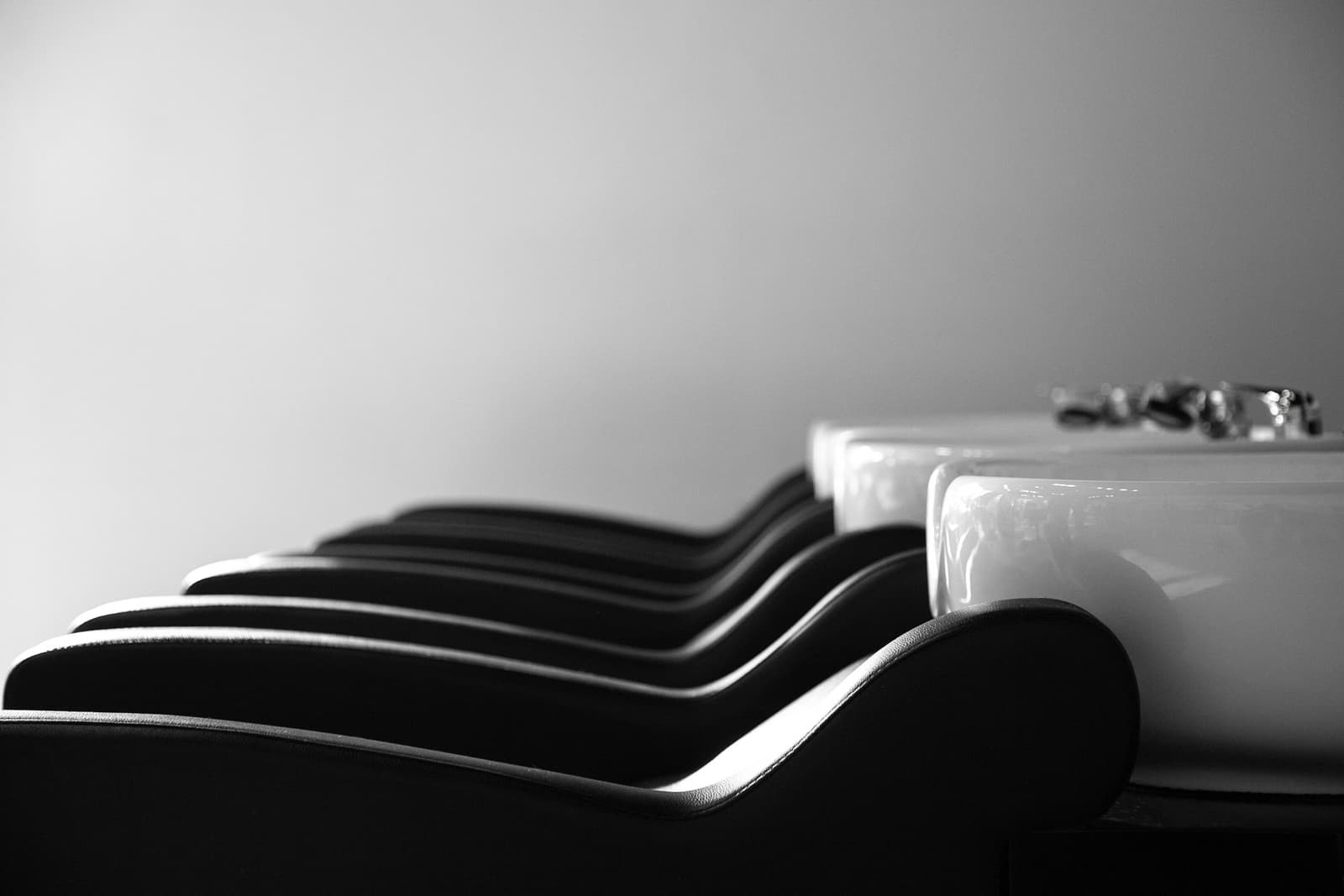 A row of black salon basins