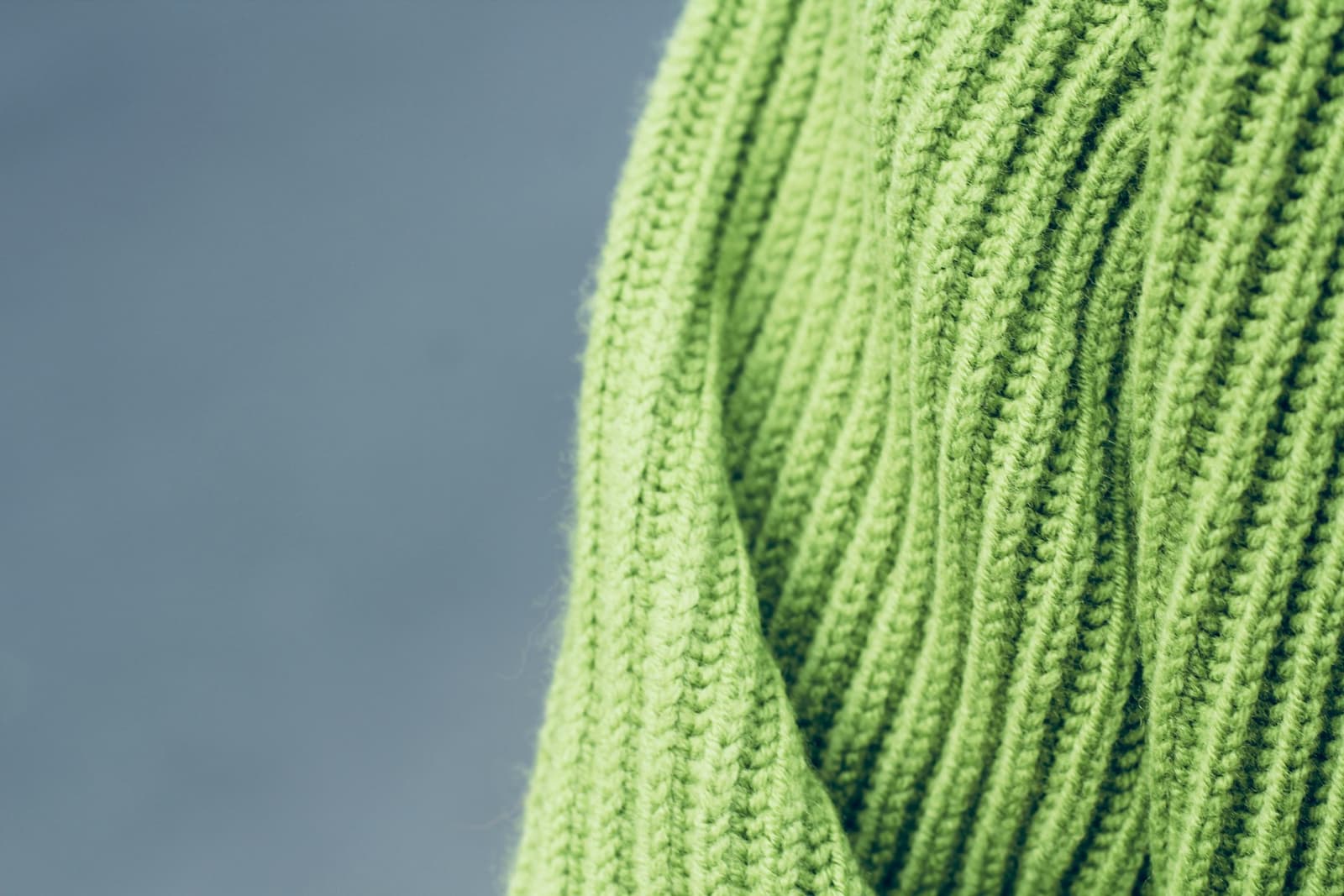 A close-up of a green knitted jumper